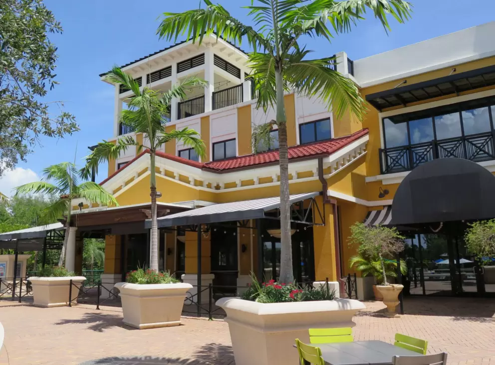 Yellow building and skinny cute palms.