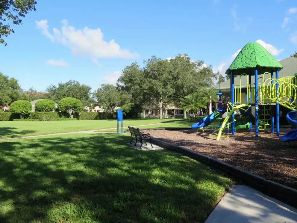 The large lawn is by the playground.