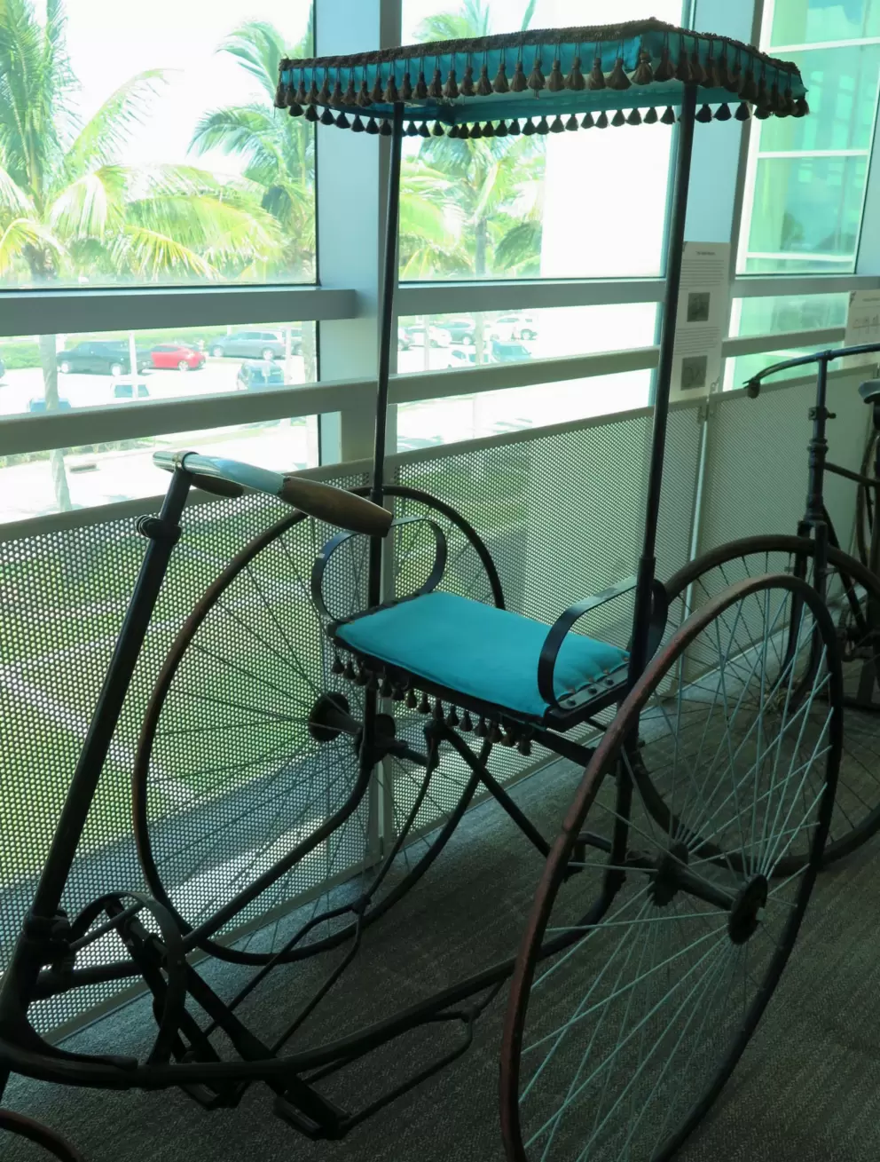 Parlor tricycle, a treadle-driven tricycle with sunroof and fringe. These were popular in the 1880s. 