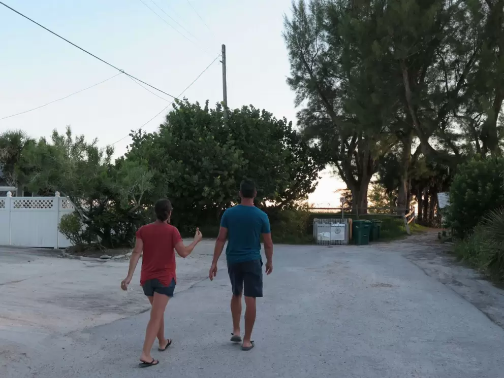The end of Pine Ave is Pine Ave Beach. A couple walks with an ice cream cone, to the beach.