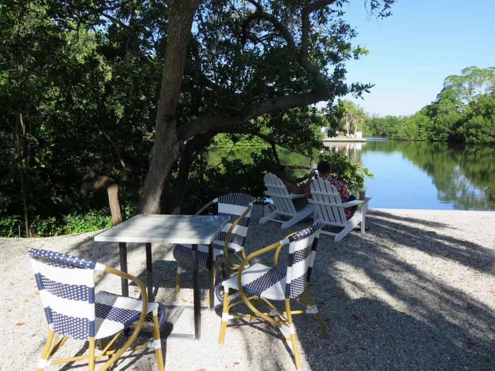 French bistro chairs and adirondack chairs by the water at North Shore Cafe.