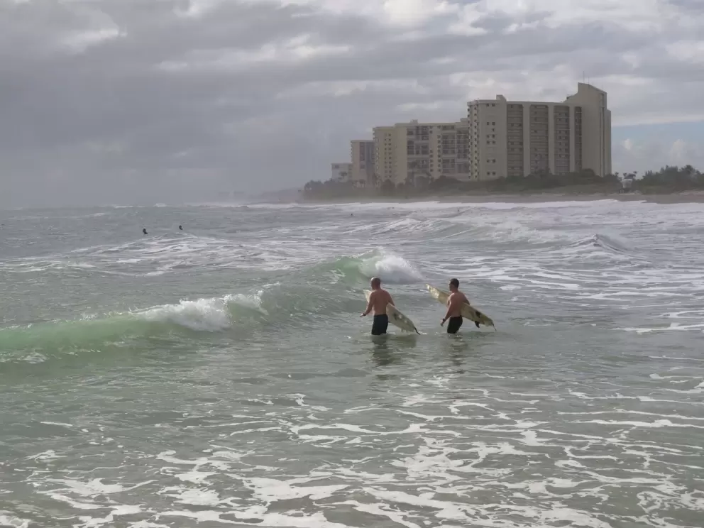 Surfers entering the water.