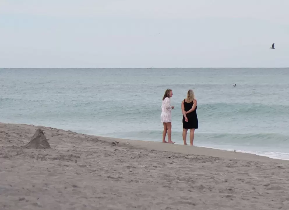 Ladies chatting at the shore.