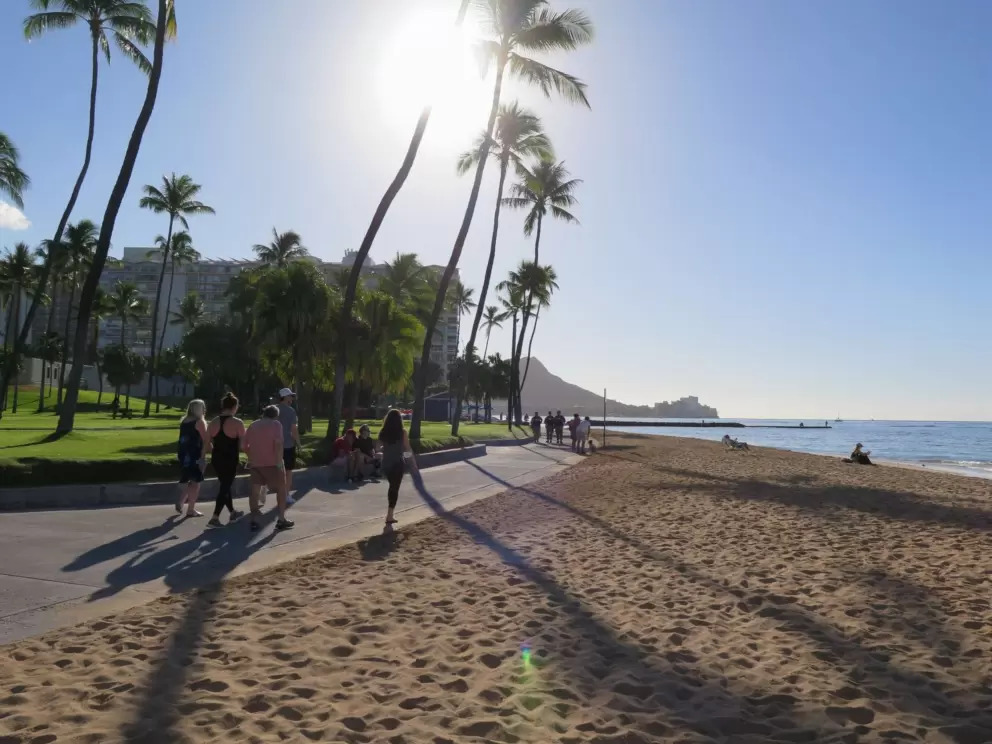 Walking along the wide boardwalk by the beach.
