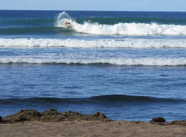Arch of spray from a surfer during a contest.