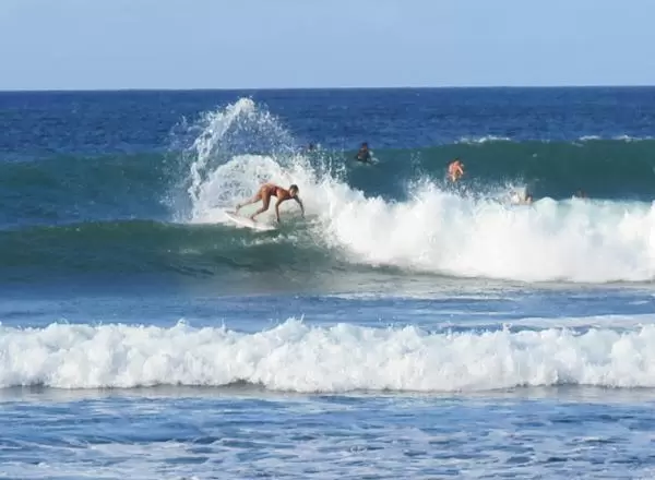 Closeup of arch of spray from a surfer.