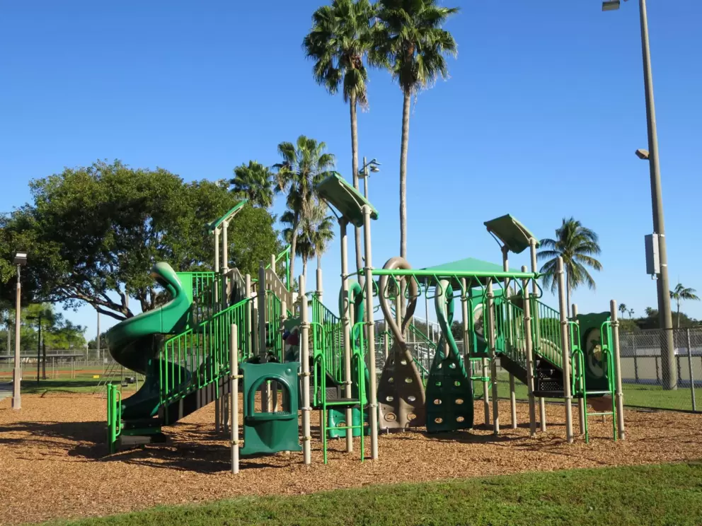 Tall green playground near the soccer fields.