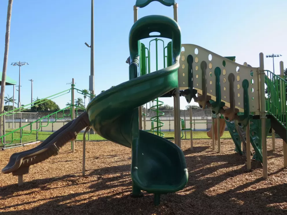 Twisty slide on the tall green playground.