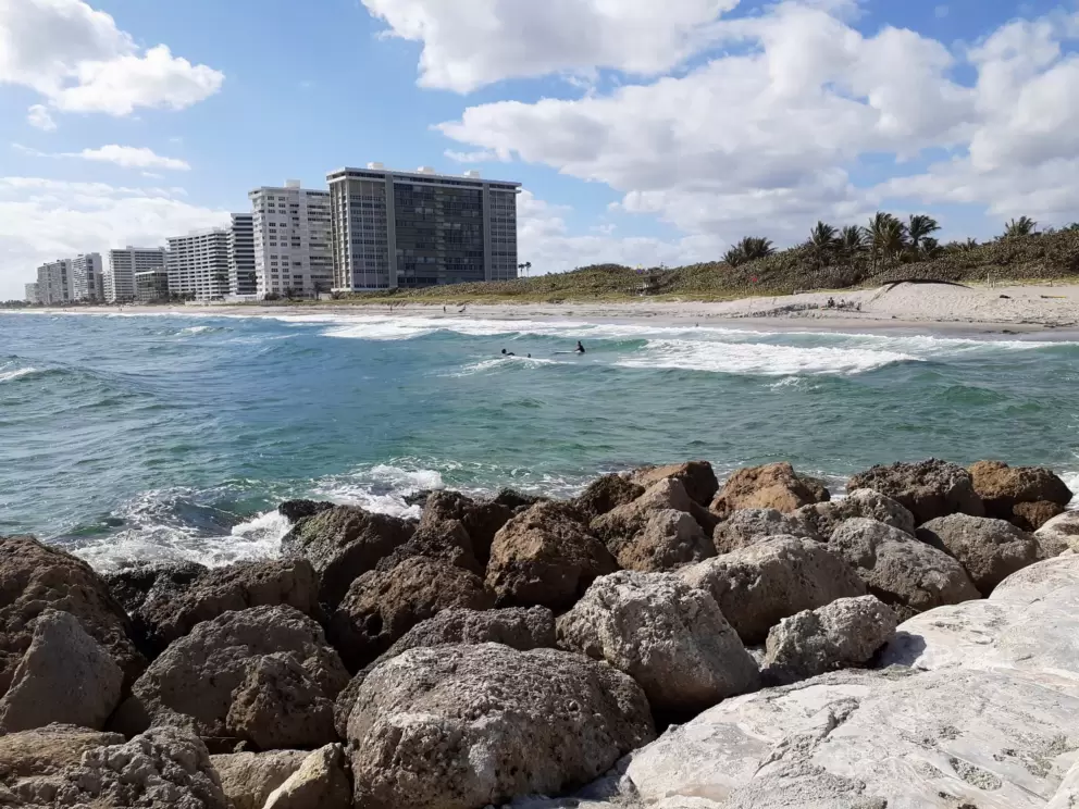 Surfers by the inlet.