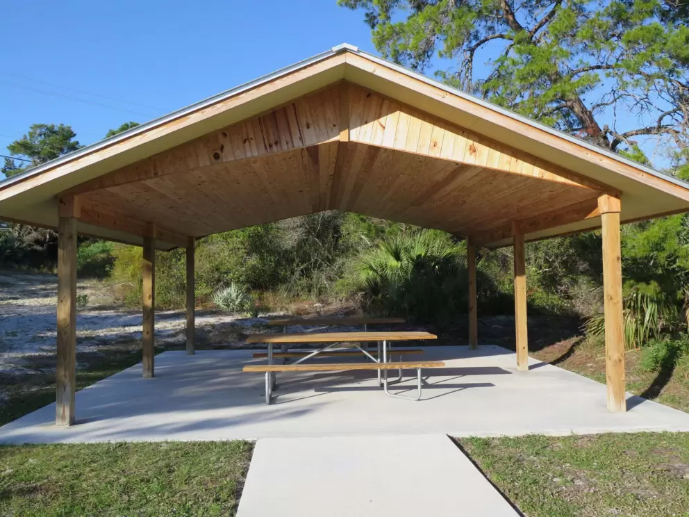The gazebo with picnic tables at the end of the crushed shell trail, where there is an entrance from Saturn Ave.