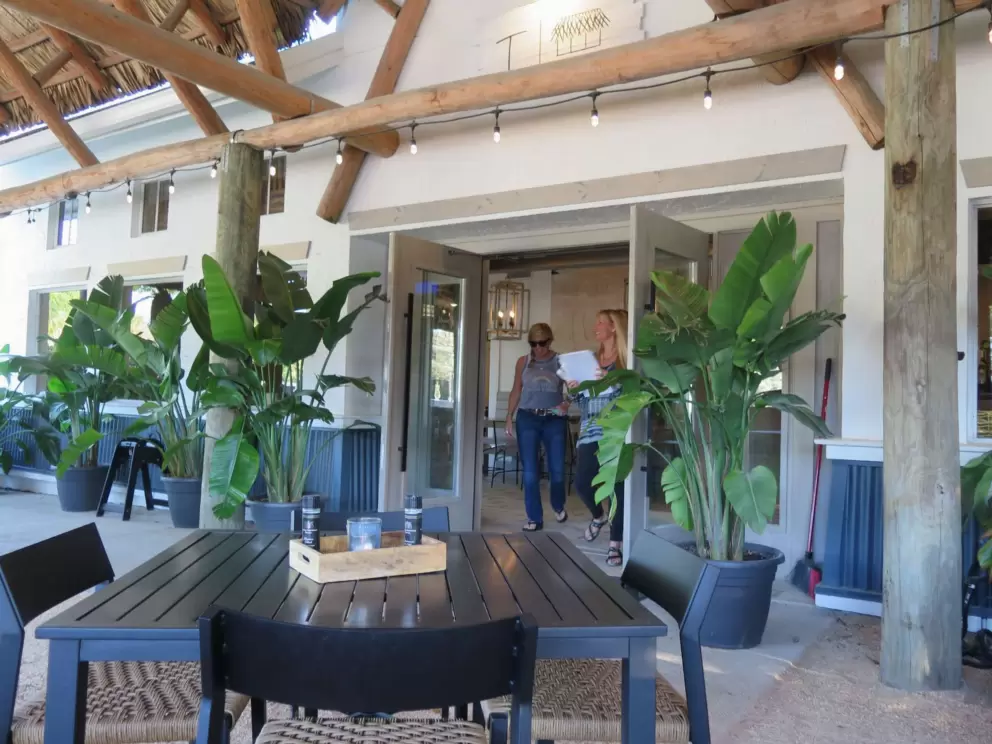 Outdoor seating under thatched roof at Taylor Beach House Cafe.