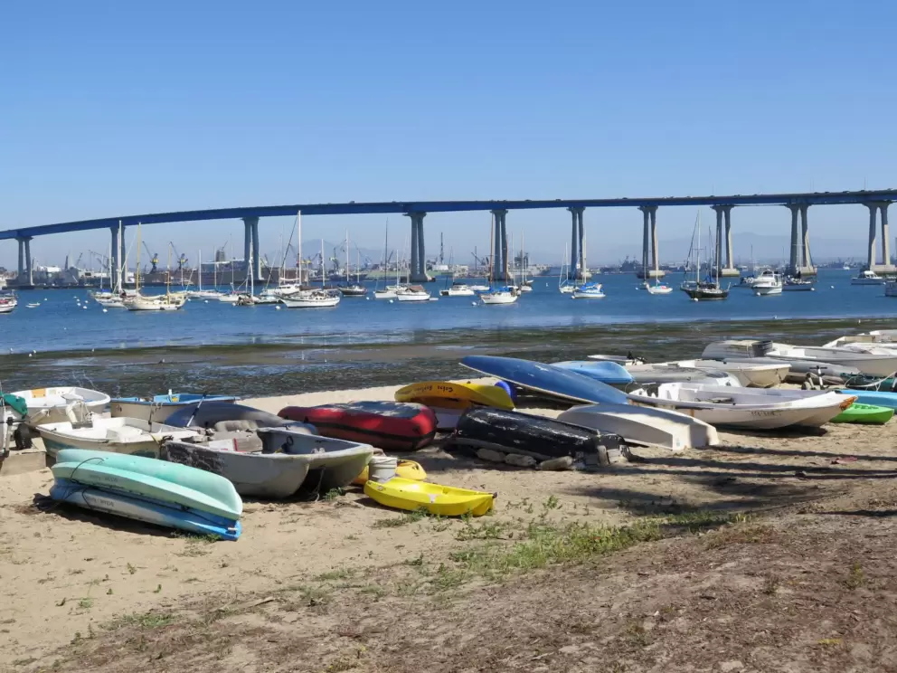 Colorful row boats and kayaks.