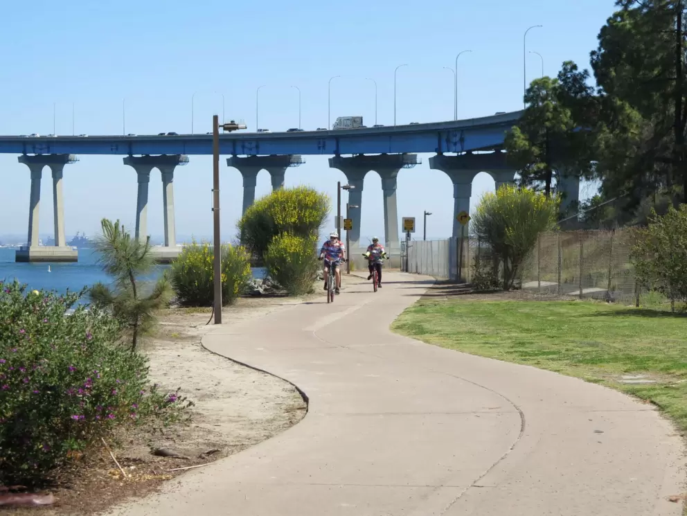 The bike path winds under the bridge.