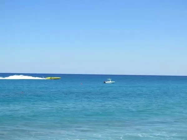 Yellow speed boat goes by.