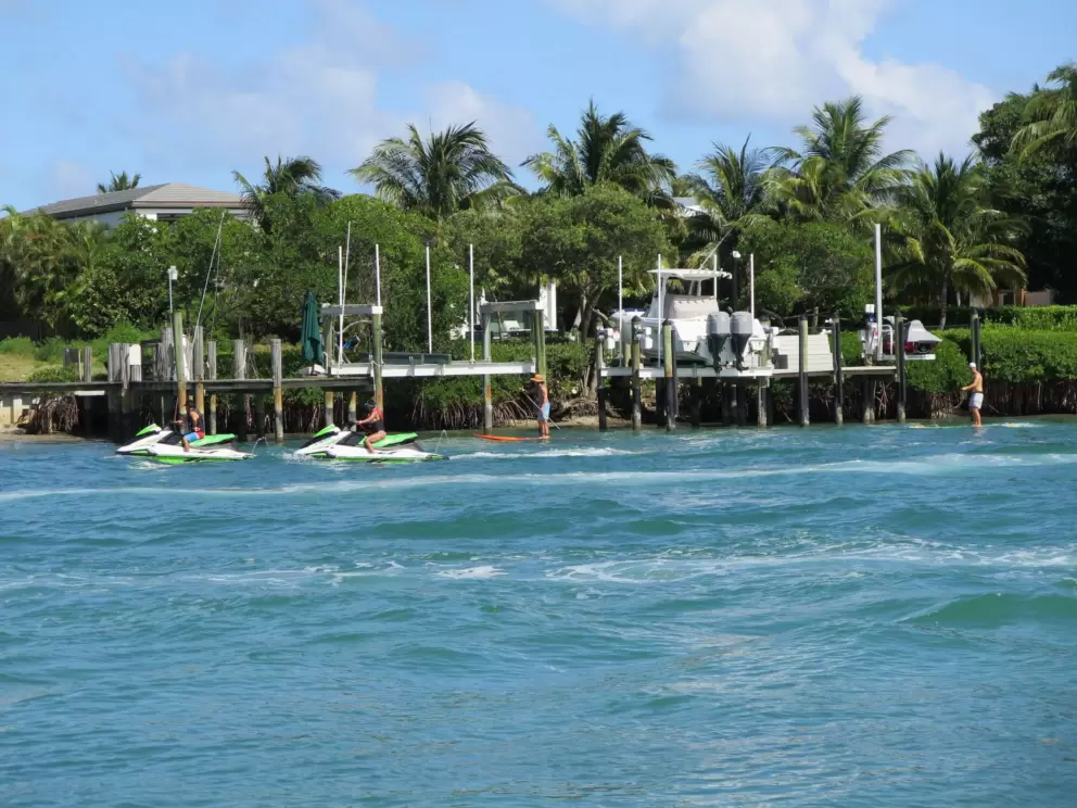 Jet skis zoom along in the gorgeous water.