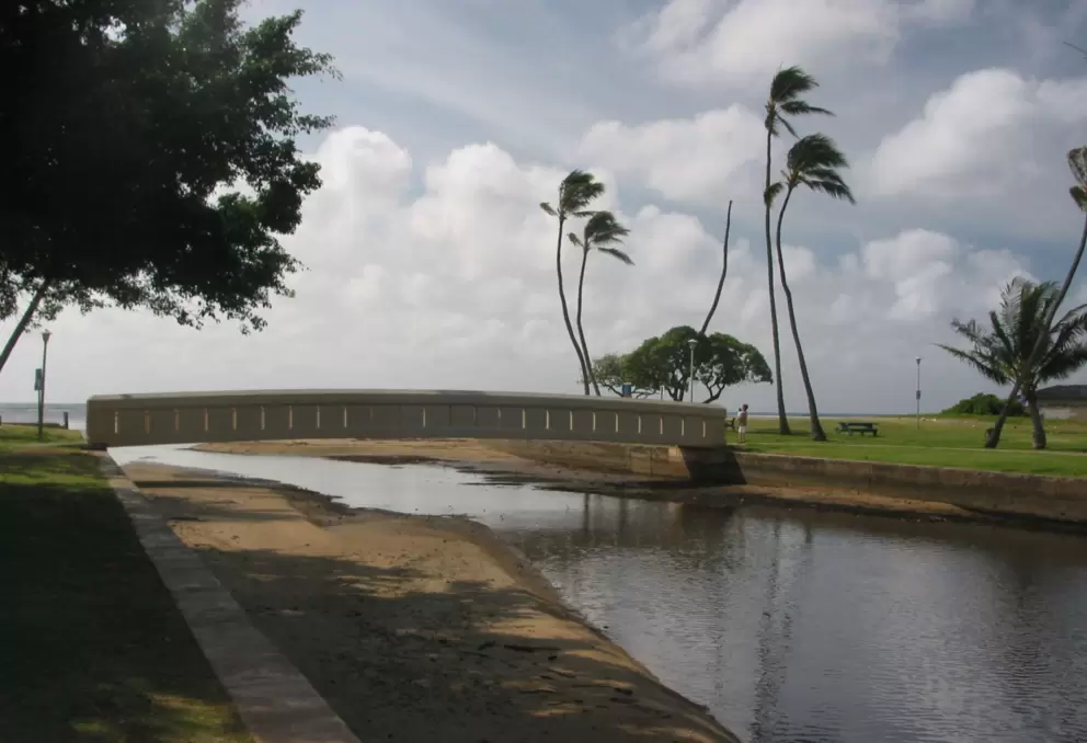 The bridge and lawn with picnic tables.