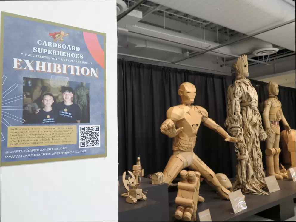 Two boys made superheroes from cardboard boxes.
