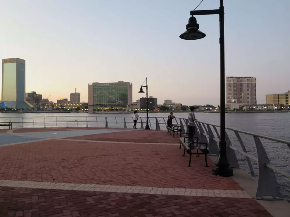 Wide open space along the riverwalk, with benches.