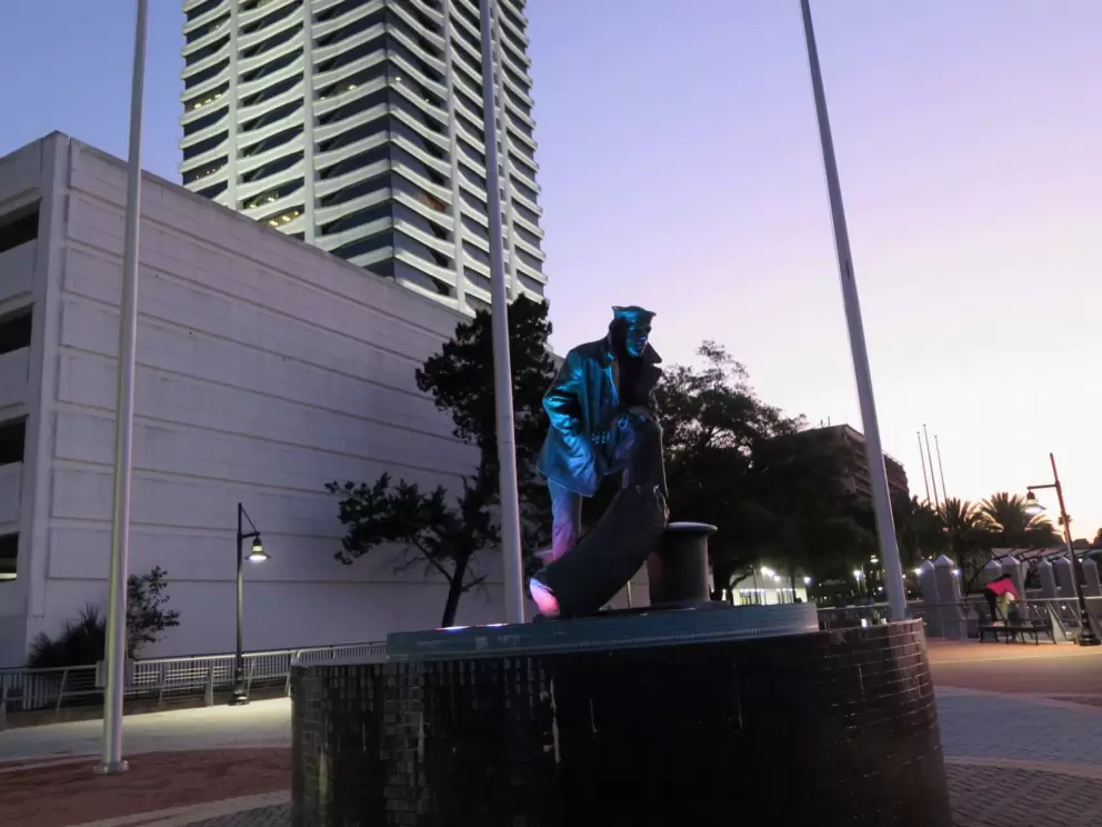 Lone Sailor Sculpture illuminated at night.