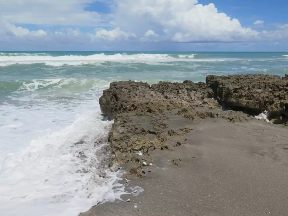 Water splashing around the limestone rocks.