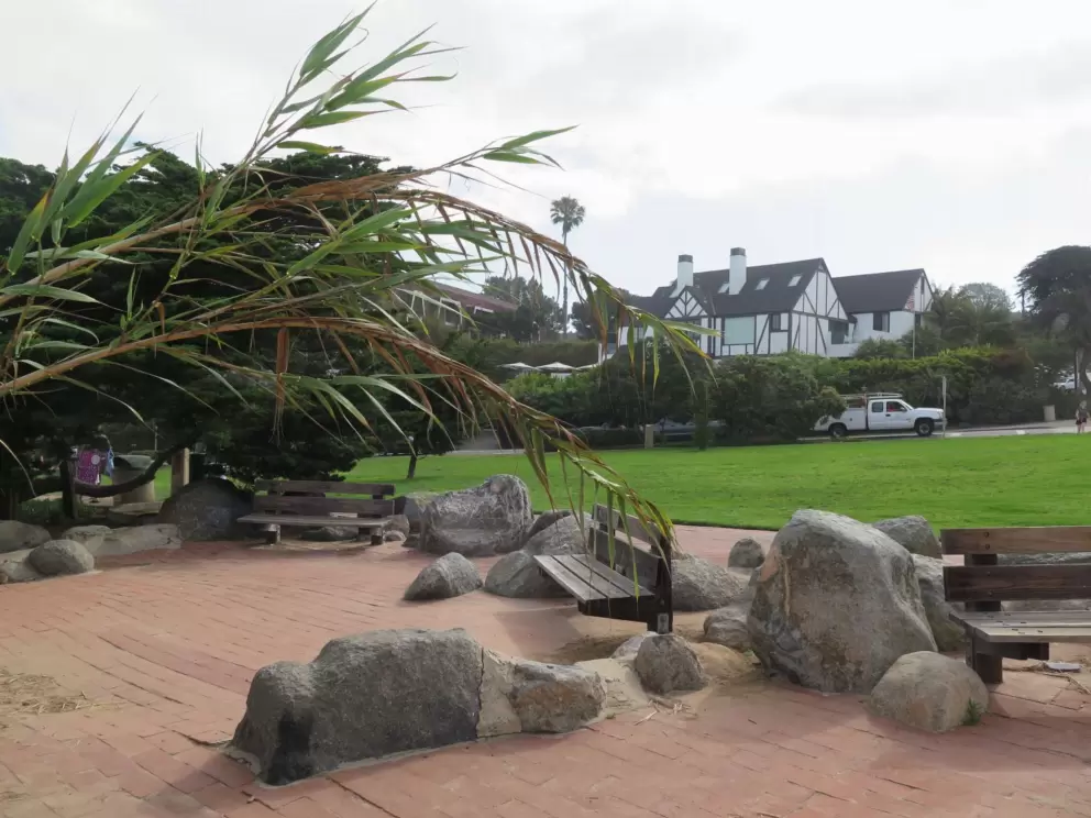 Half-timbered house across the street, and boulders by the cliff edge.