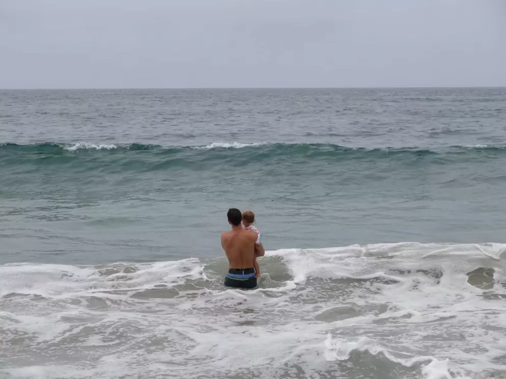 A dad and baby going for a swim.