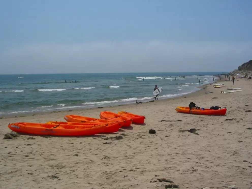 Kayaks on the sand at Campus Point.