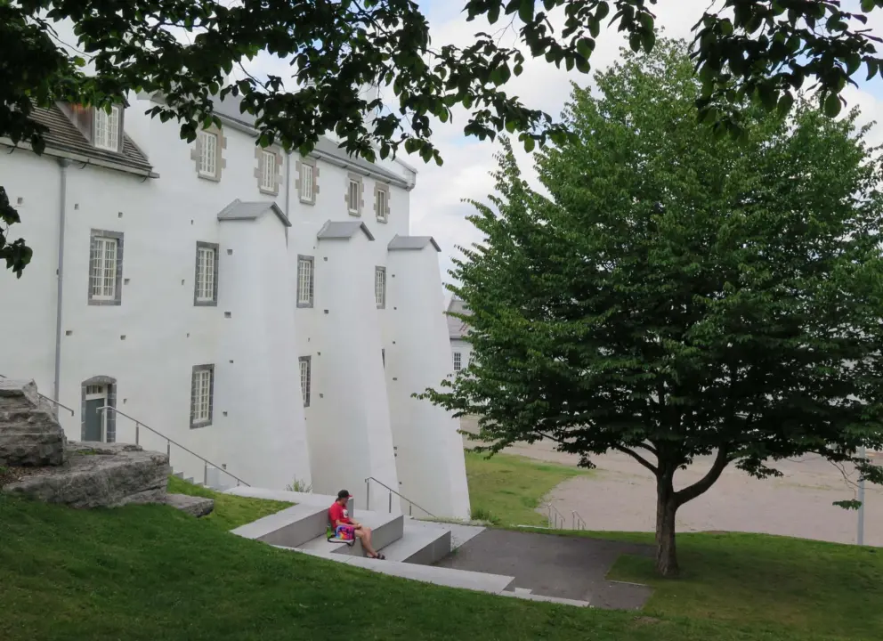 A young man reads on the steps behind Dauphine Redoubt. 