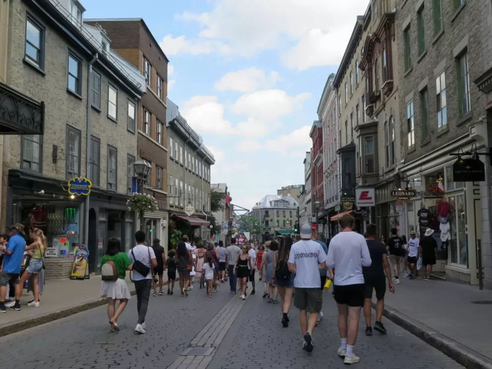 Crowds of people pack the street.