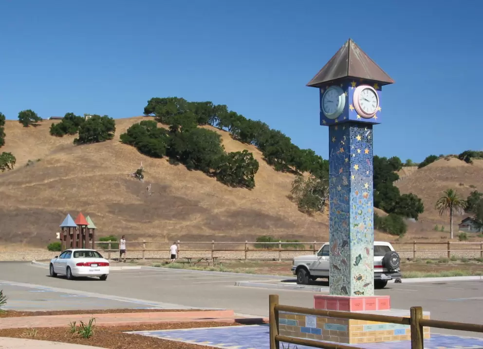 The magical clocktower at the entrance. Rolling golden hills with clusters of trees- a typical Solvang countryside scene. 