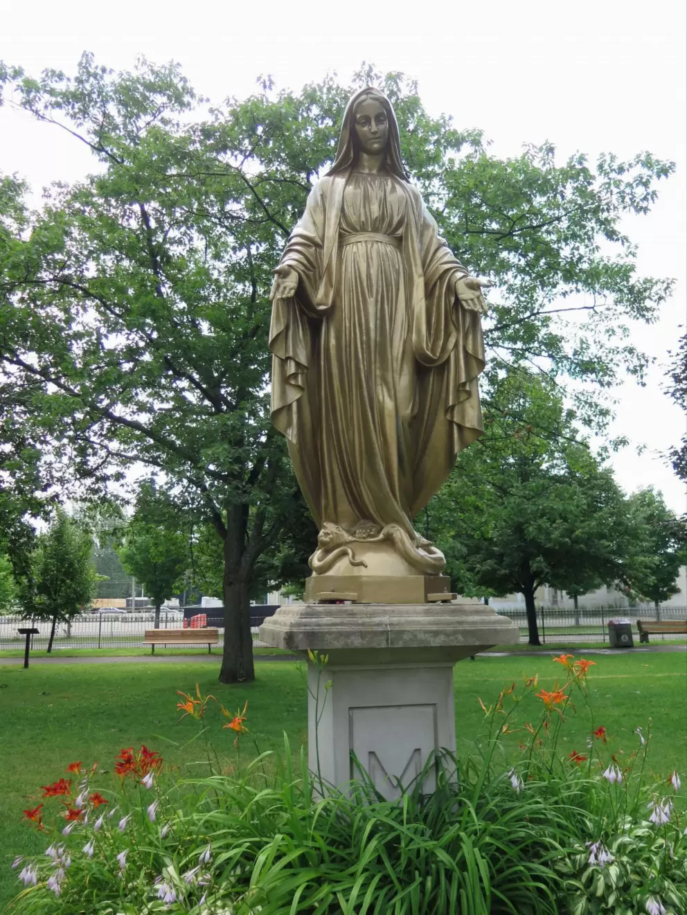 Mary reaching out her arms to you.