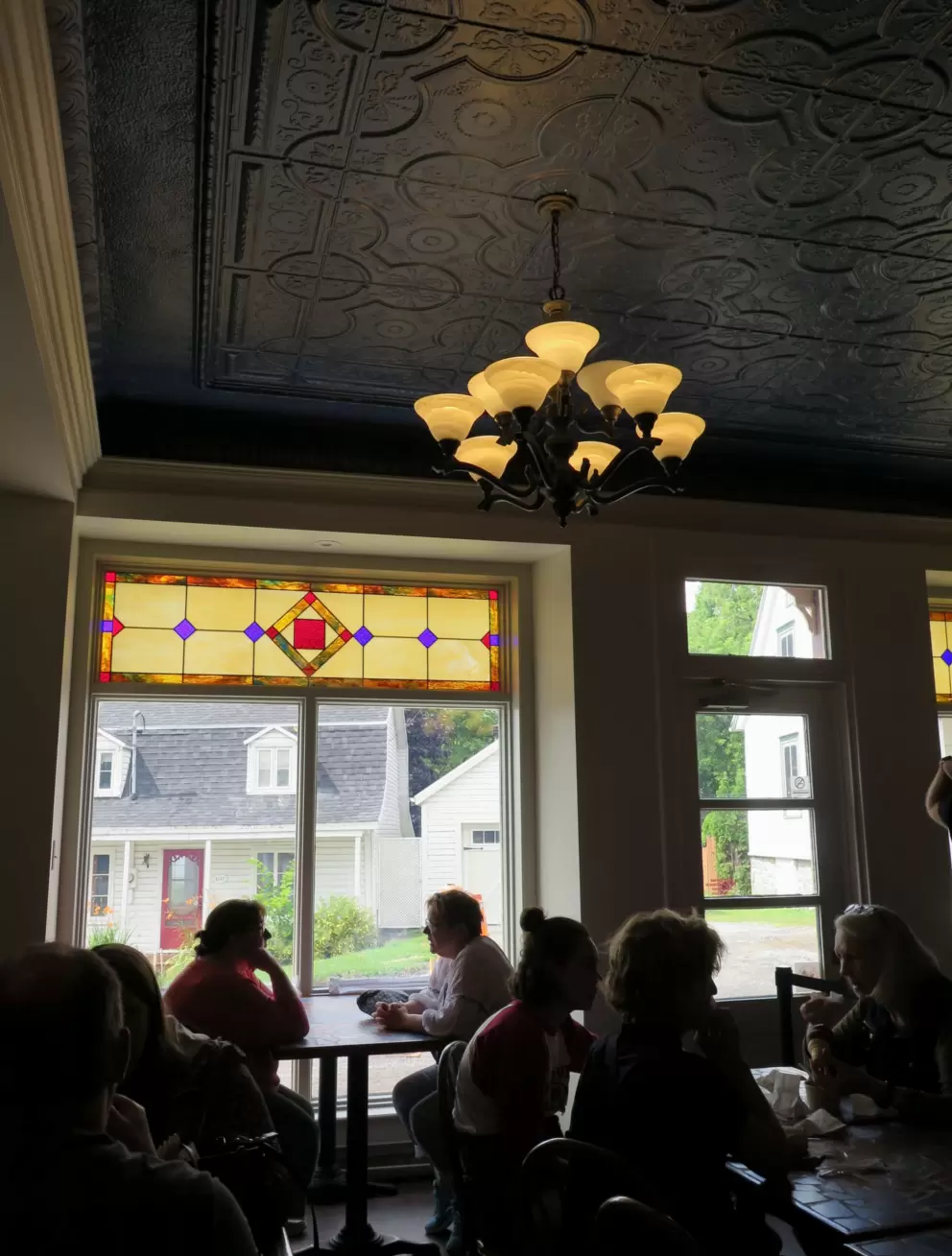 Cute place to sit with stained glass window and fancy ceiling at the chocolaterie. 