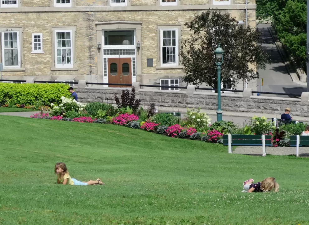 Kids rolling down the hill.
