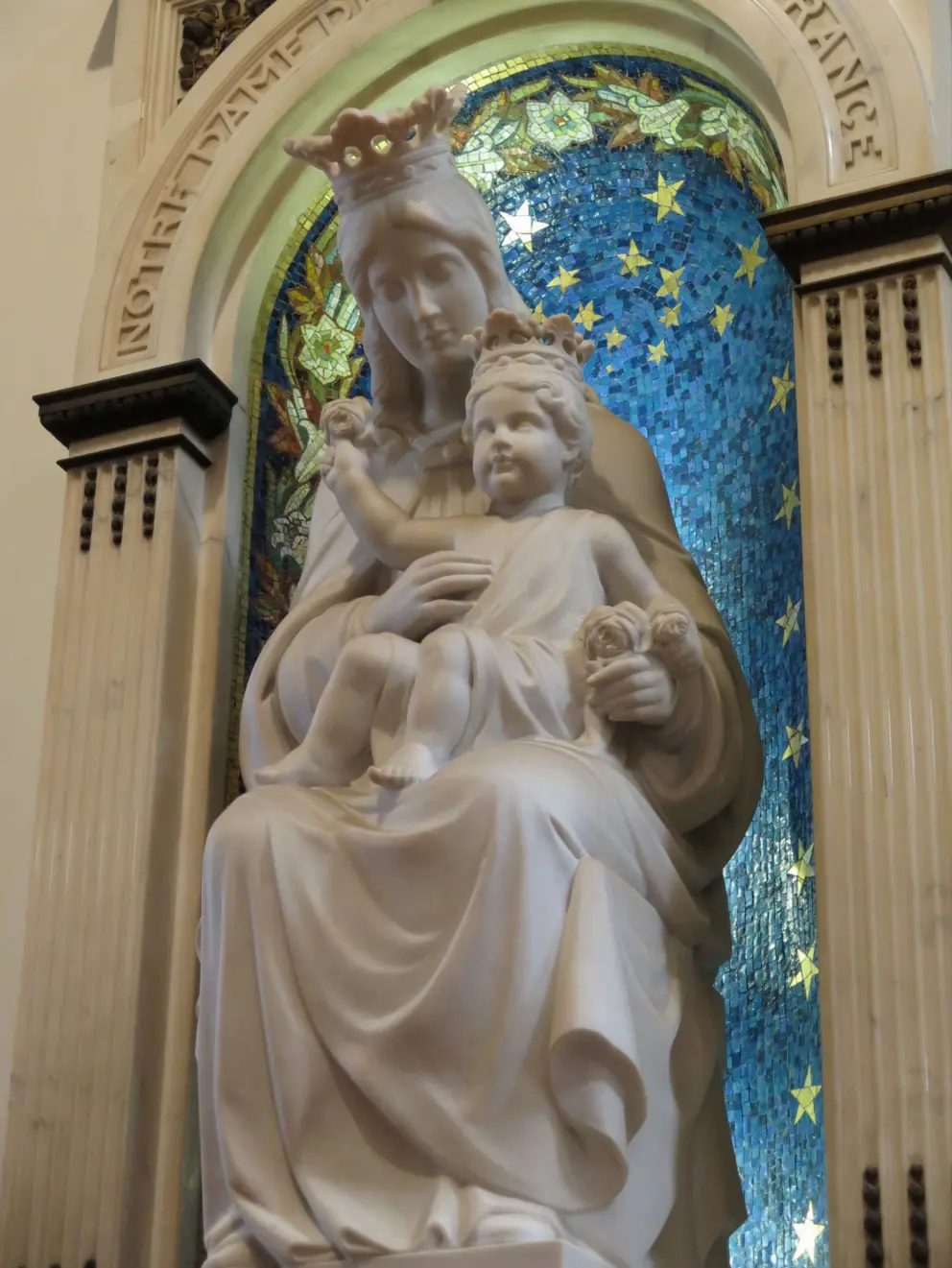 Mary, crowned, with baby Jesus.