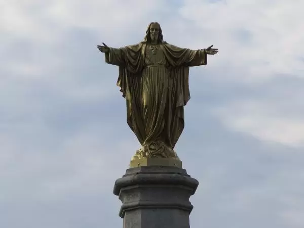 Jesus, with arms outstretched, next to St Jean Baptiste Church. 