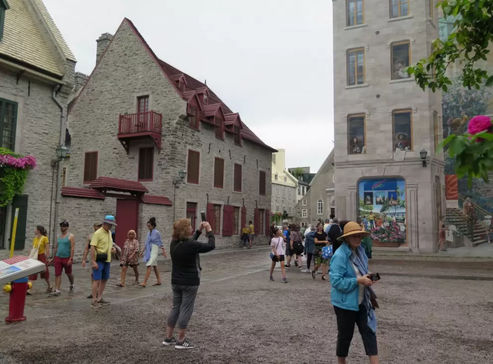 Tourists check out the mural.