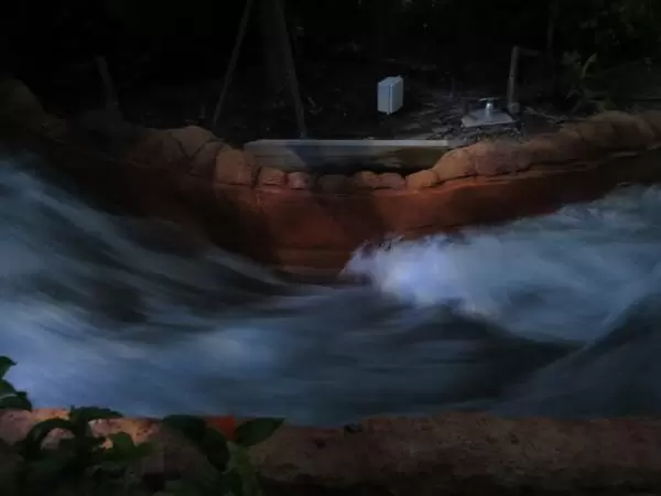 Watching the water rush by, at Infinity Falls. 