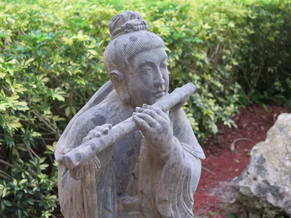 Flute player sculpture in the gardens. 