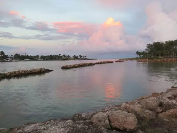 Swimming area on the inlet, and pink clouds reflected. 