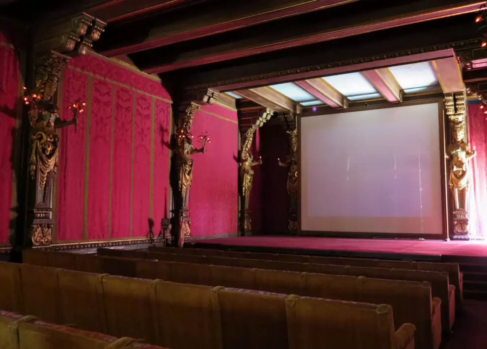 The movie room and its red damask walls. 