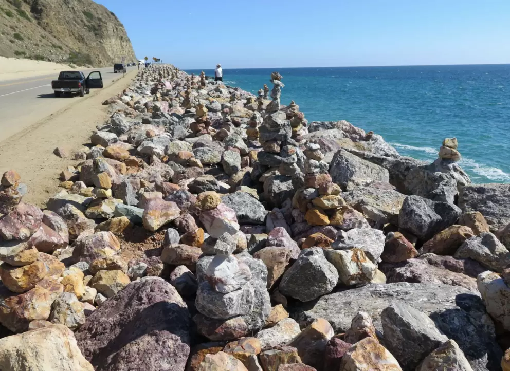 People stopping to check out the rock cairns.