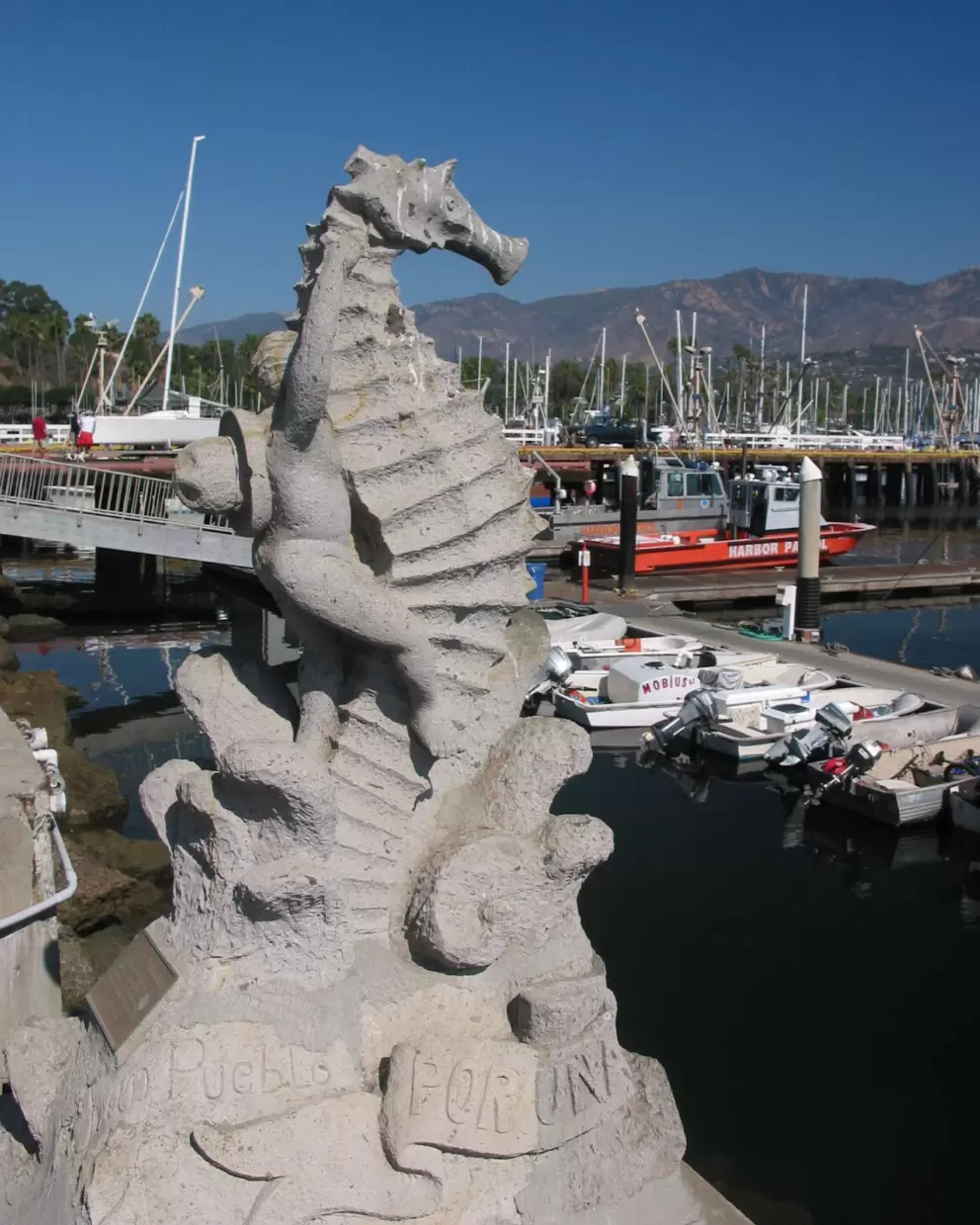 Statue of boy riding a sea horse, at the harbor.