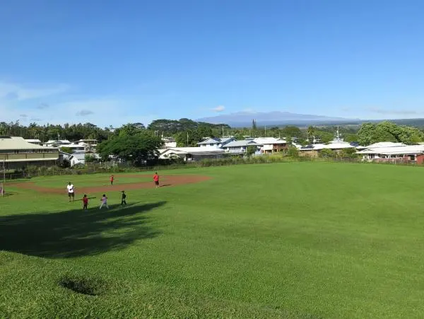 Kids enjoying the baseball diamond. 