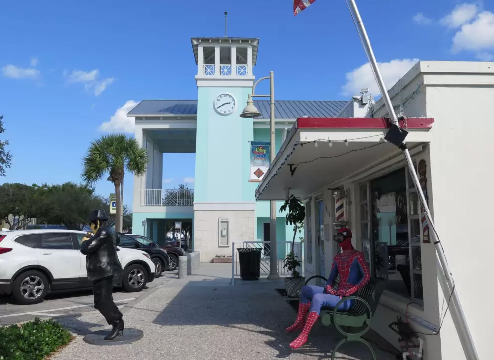 Spiderman on a bench, near the Caribbean blue tower. 