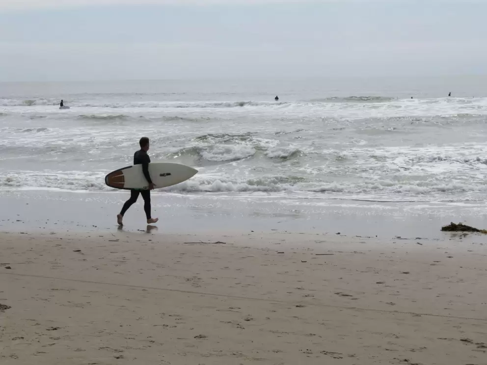 A surfer heading into the waves. 