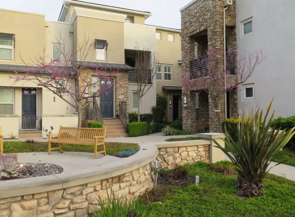 Stone wall and townhomes. 