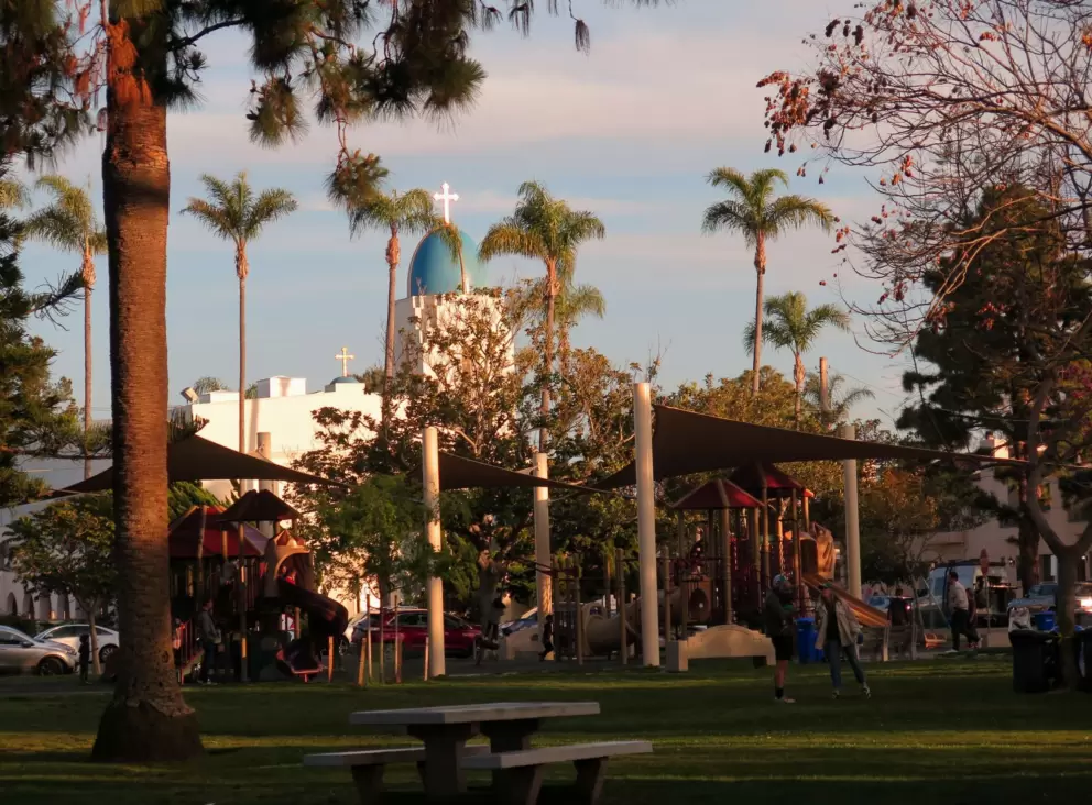 The playground with canopies, and Sacred Heart Church.