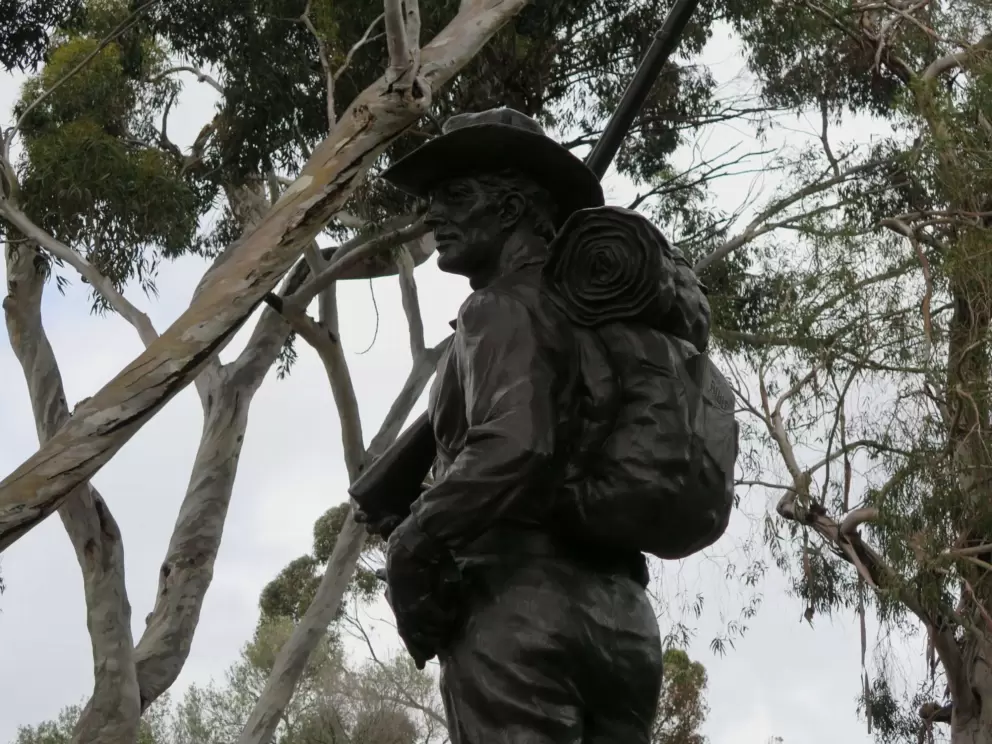 Charlie statue with a hat and rucksack. 
