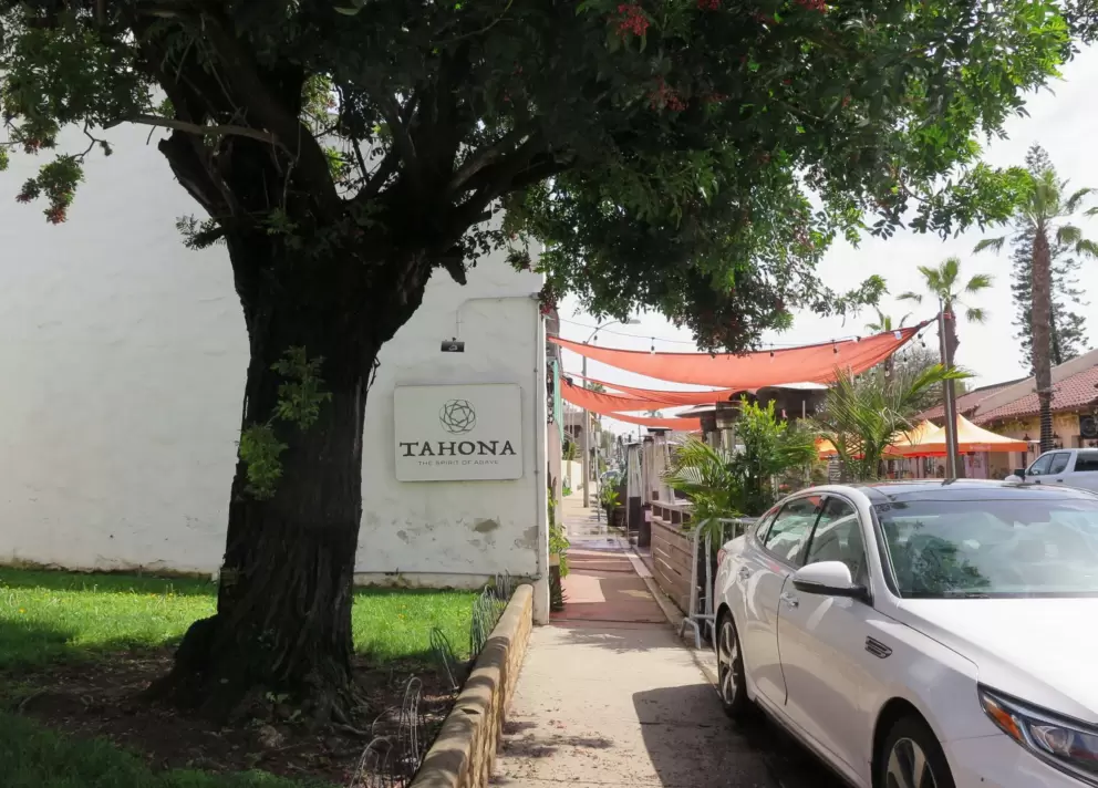 Cafe with peach-colored shade canopies. 