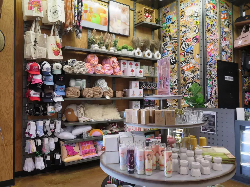 Store with candles, blankets, hats, and bags. 